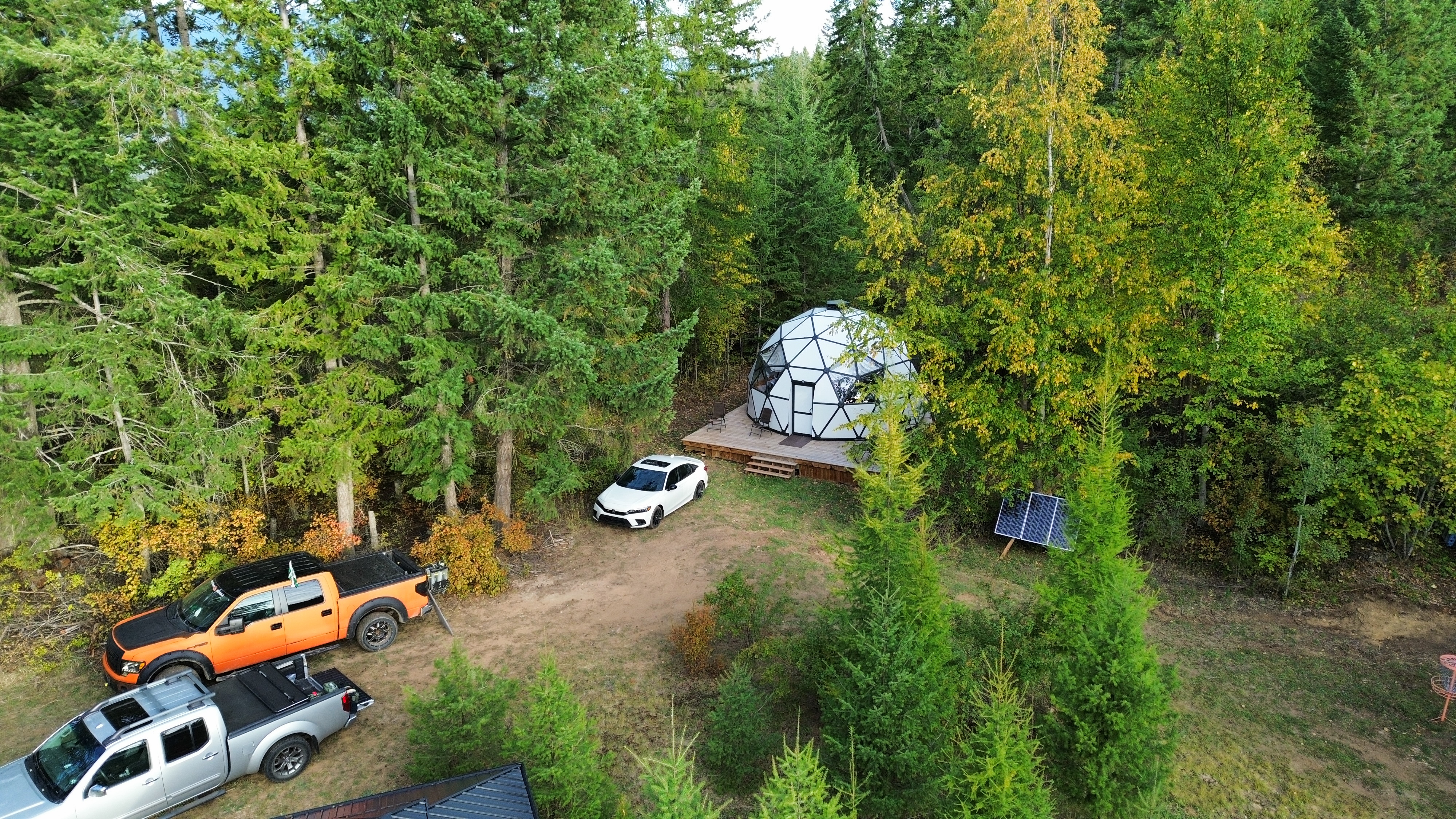 Drone shot of vehicles parked in front of the dome
